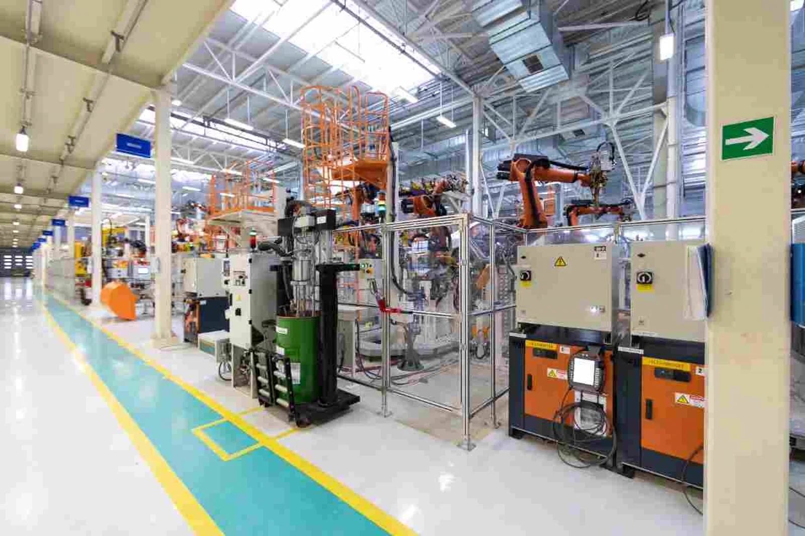 US automotive parts manufacturing factory floor with robotic machinery