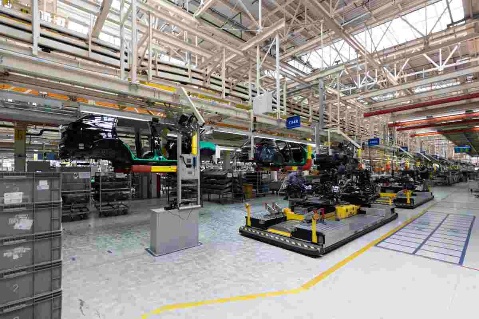Automotive factory production line with car chassis on an overhead conveyor